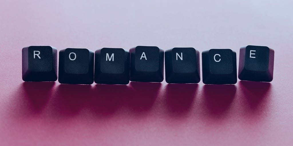 ROMANCE in keyboard letters on a light pink background