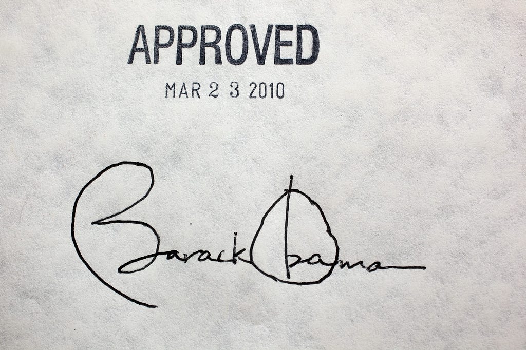 Barack Obama’s signature on the Affordable Care Act. Text reads Approved Mar 23 2010; Barack Obama