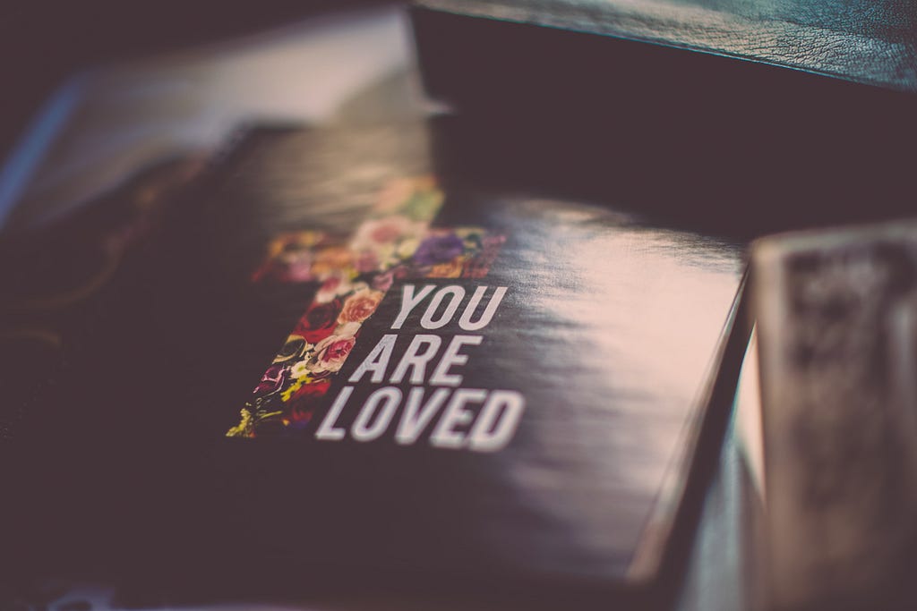 image of bible with text, “you are loved”