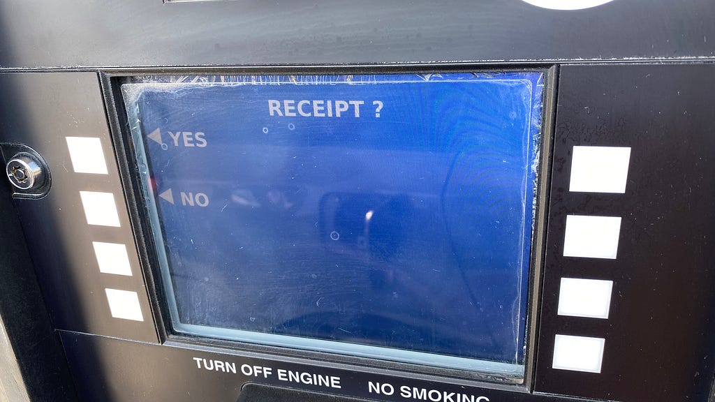 The blue payment screen at a gas pump that asks you if you want a receipt.