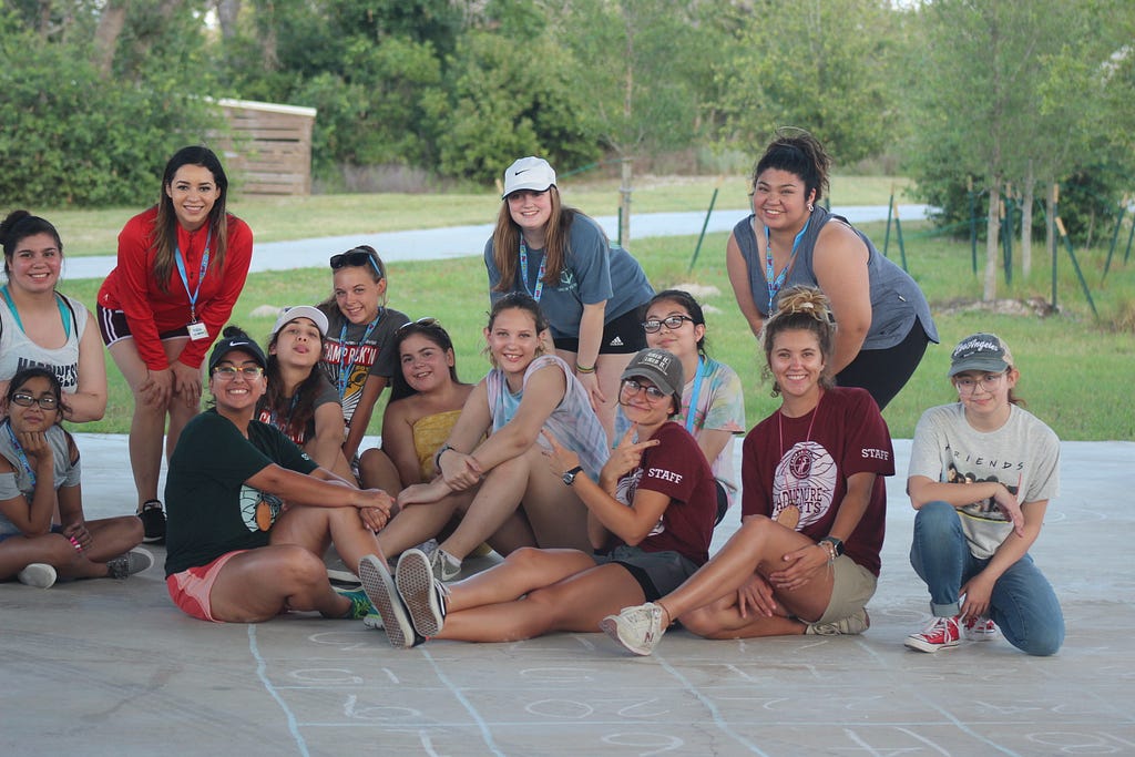 campers and activity leaders gather around under the pavilion