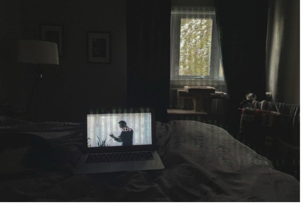 Image of a laptop on a bed in a dark room, featuring a man dancing with the title ISLANDS displayed across it. A small amount of light filters in the window, and green digital lettering appears between the light of the window and laptop.