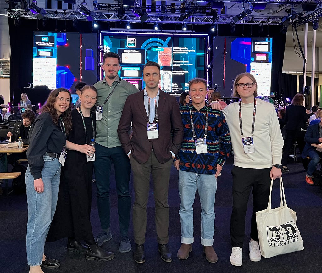 Members of the EQT Motherbrain team standing in the main pavillion at the Data Innovation Summit 2023 in Stockholm, Sweden.