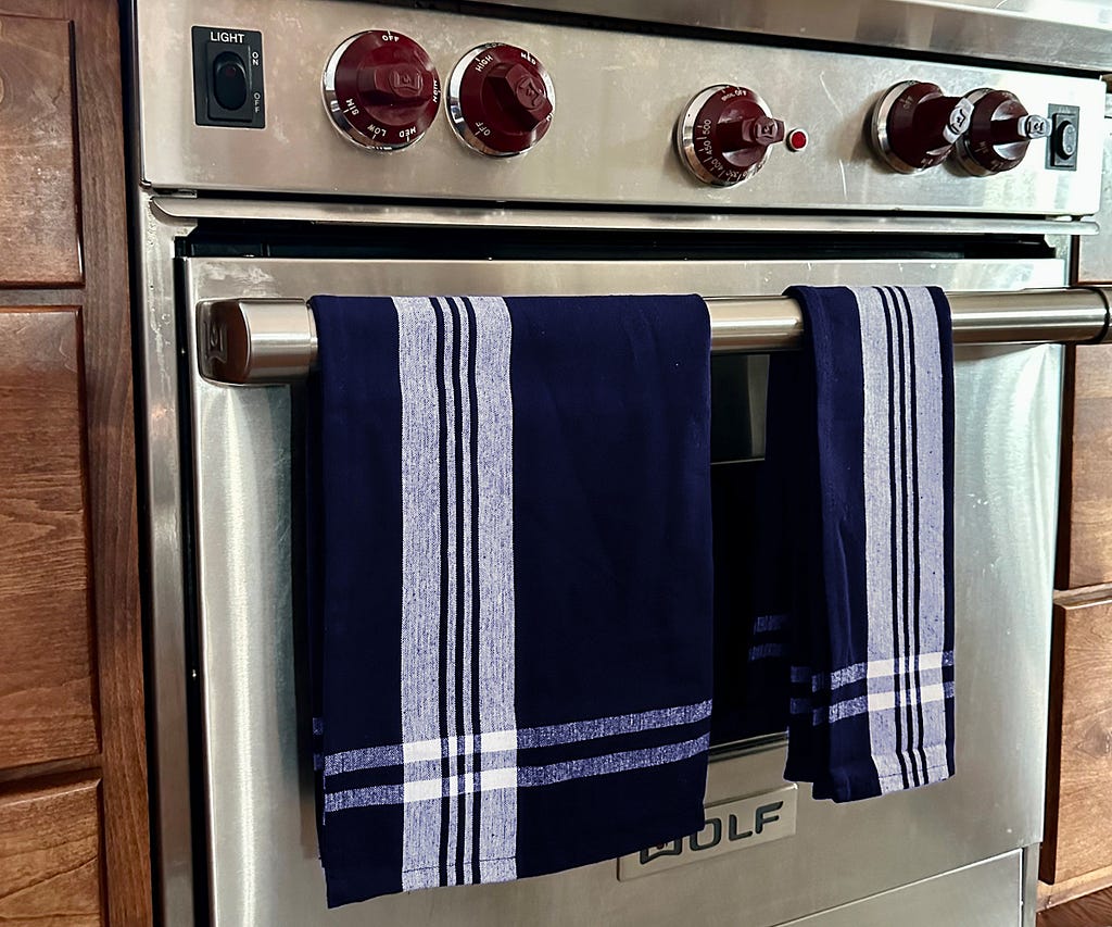 Close-up of striped kitchen towels hanging on a hook