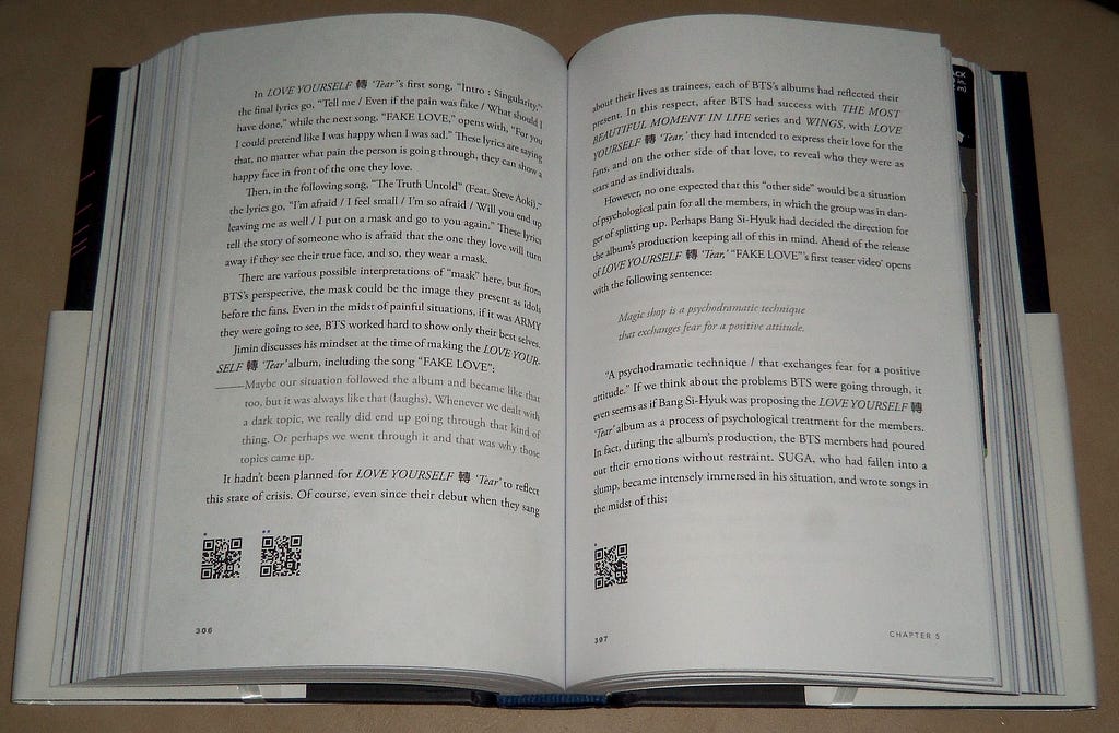 Open book showing QR codes on the bottom of the pages.