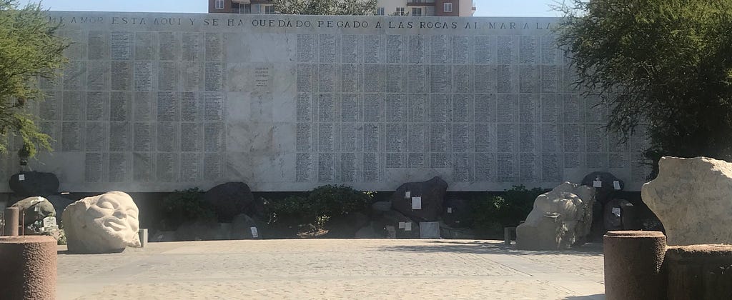 Stone wall listing thousands of names