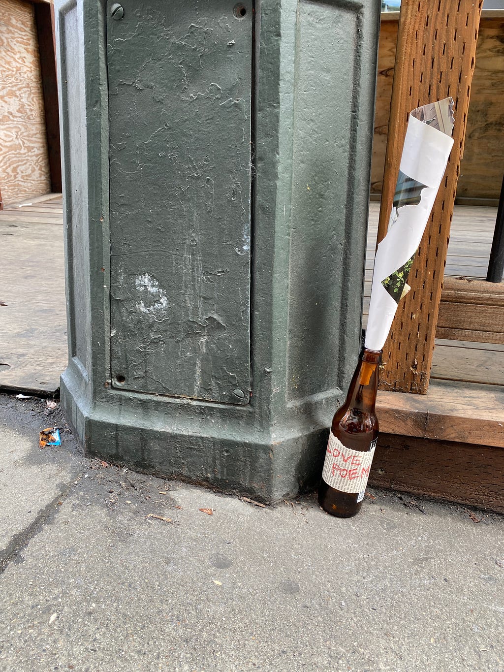 love poem in bottle on sidewalk