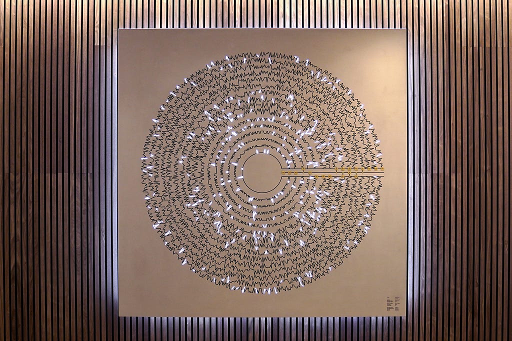 Metal artwork on a wooden wall