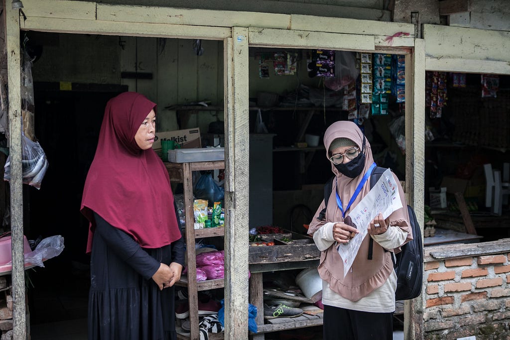 Sri Rostiaty visited Farida at her shop to monitor the prevention practices, as well as to update her with the latest information around COVID-19. Photo by Andri Ginting