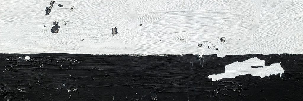 Textured surface painted half black and half white. Marks of each colour are on each contrasting side.