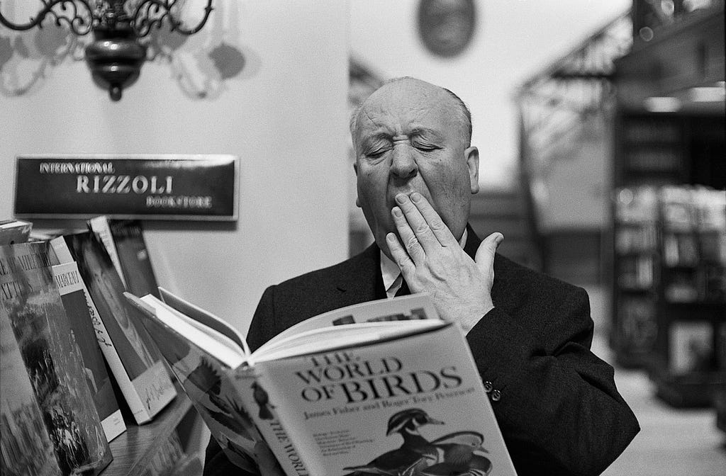 Hitchcock reading a book