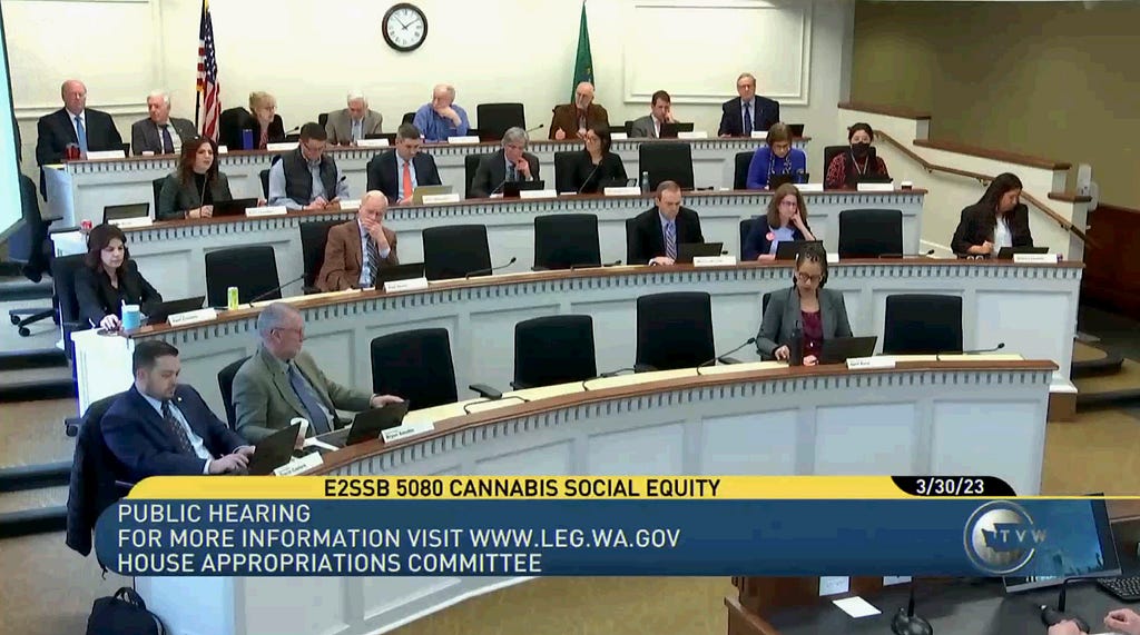 A screenshot of legislators sitting in session with an overlay from TVW