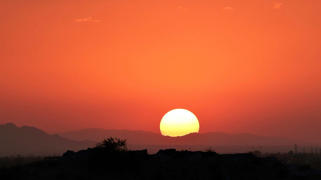 Setting sun over desert.