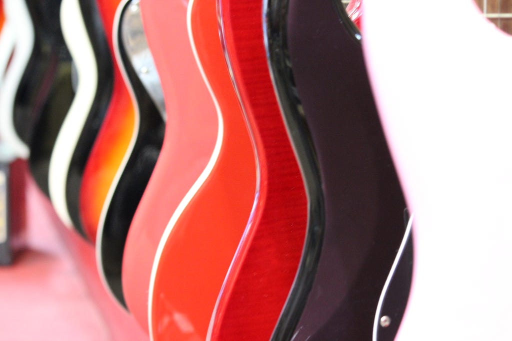 side view of guitars hanging on display