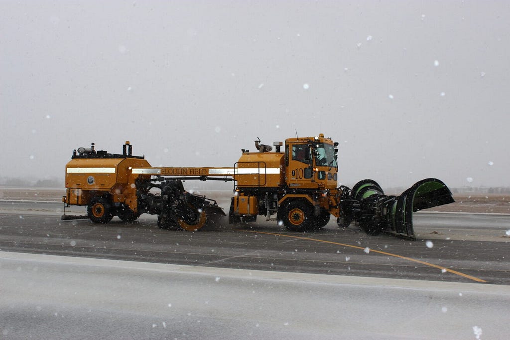 A snowplow clearing the runway at Williston.