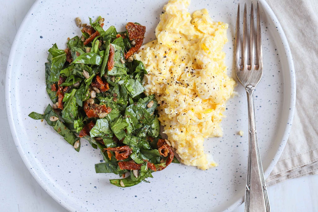 Goat Cheese Scrambled Eggs with Spinach Pesto Salad by FIT & NU.