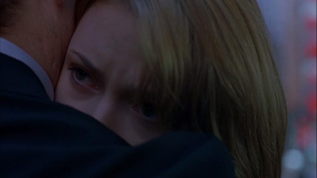 Scarlett Johansson, a blonde woman, embraces Bill Murray, a white man. The shot is framed to focus on the upper part of Scarlett’s face, emphasizing her eyes, which are welling up with emotion.