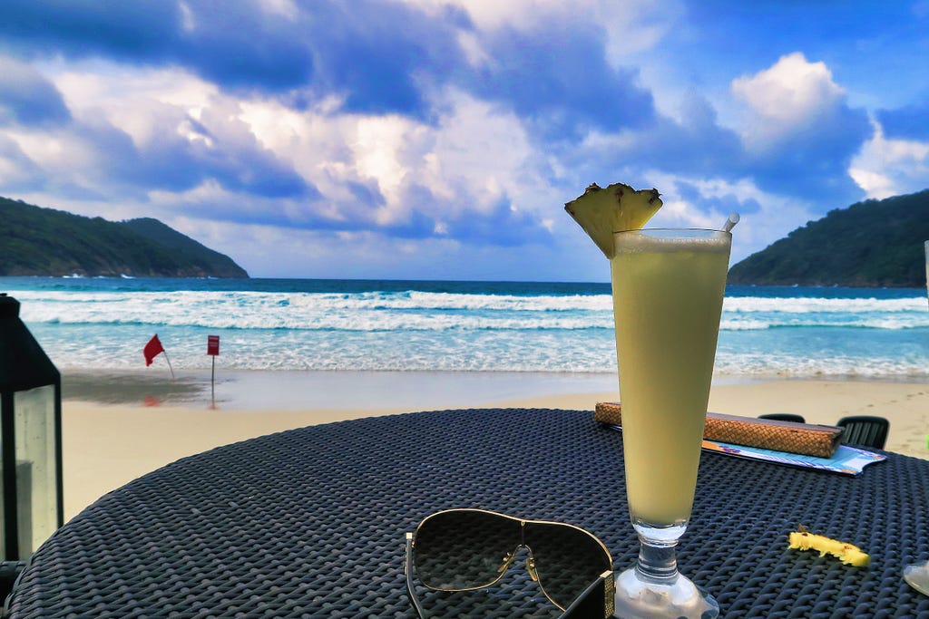 Travel and see the world. Image of an Ocean with cocktail