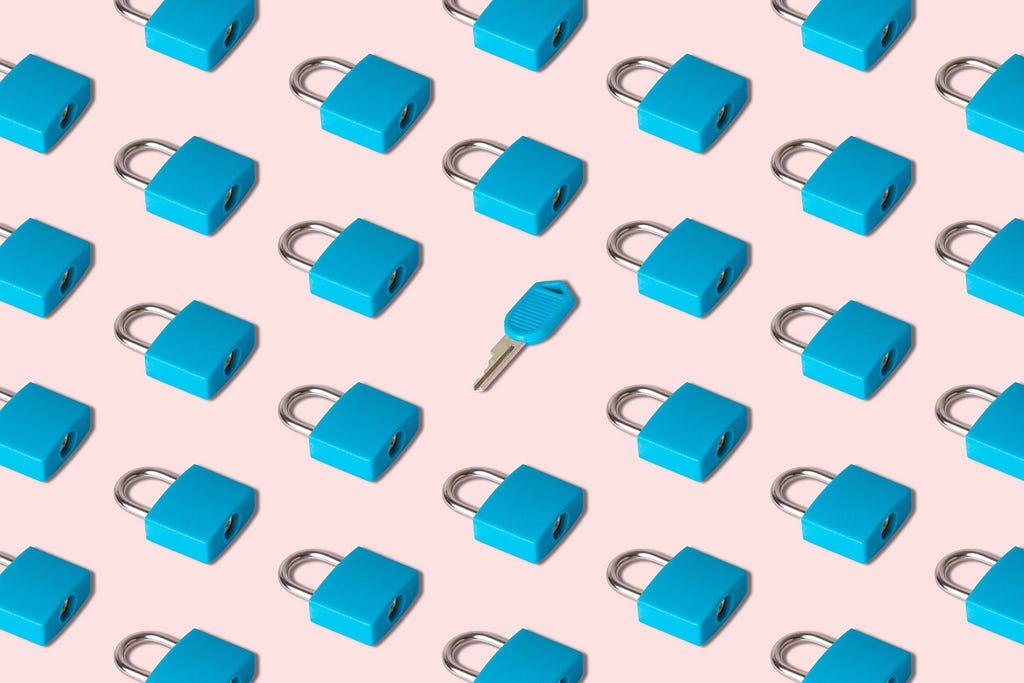 Image of blue padlocks against a pink background with single blue key