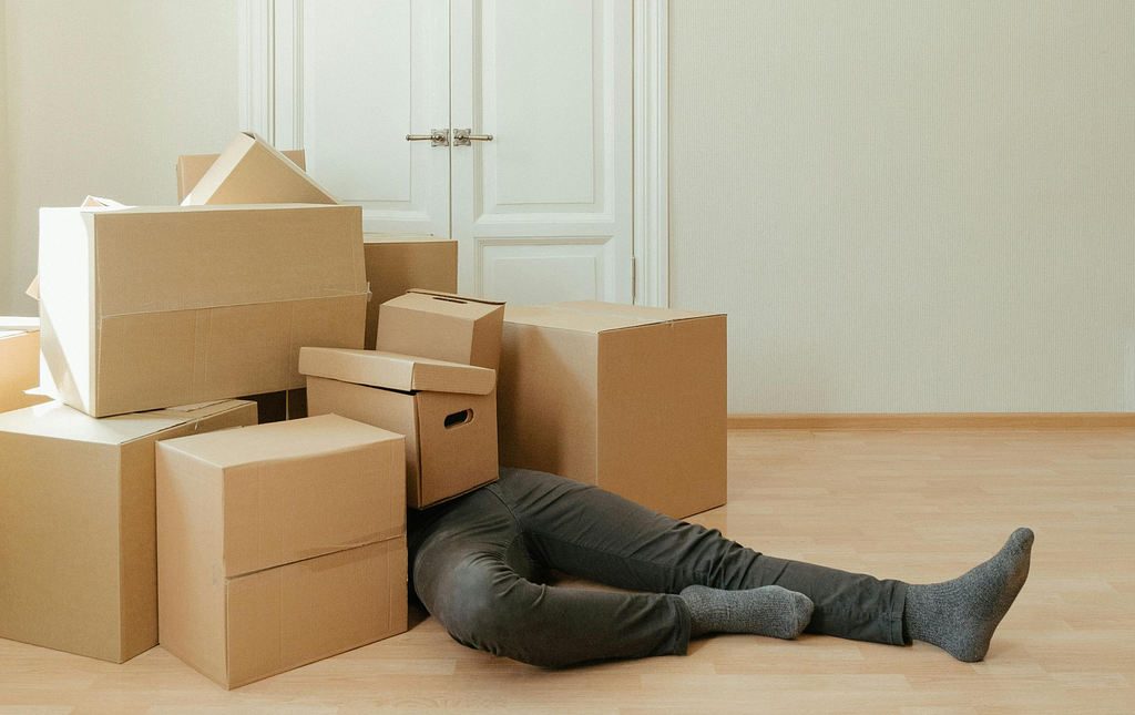 A person lying down with boxes all over them