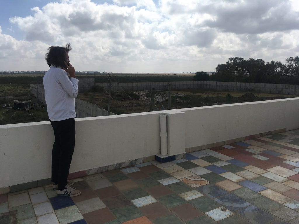 Alex Pitkin on the rooftop of Roam HQ in Nairobi, overlooking industrial scrubland