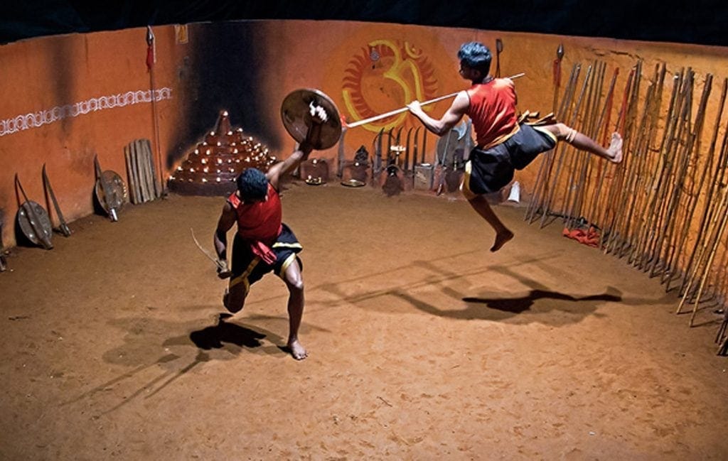 Two Indian students train in Kalaripayattu weaponry.