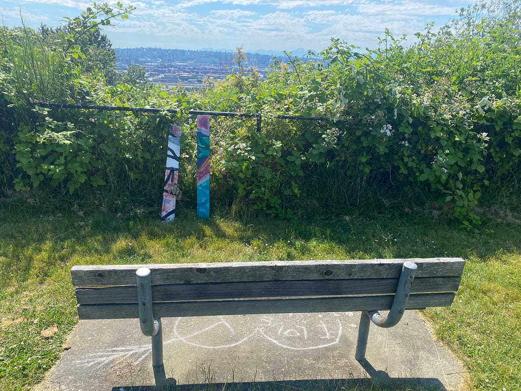 trash sculpture in front of bench