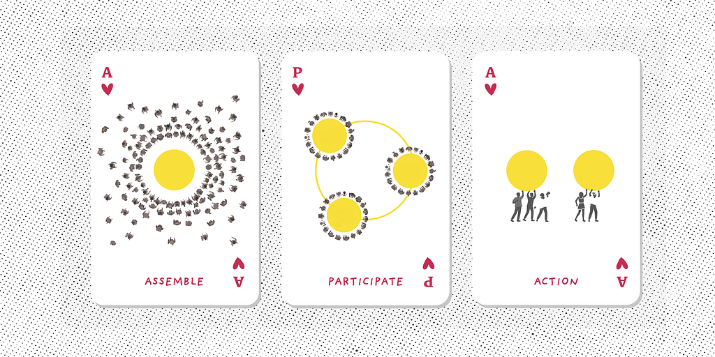 Three playing cards with “assemble”, “participate” and “action” written on them