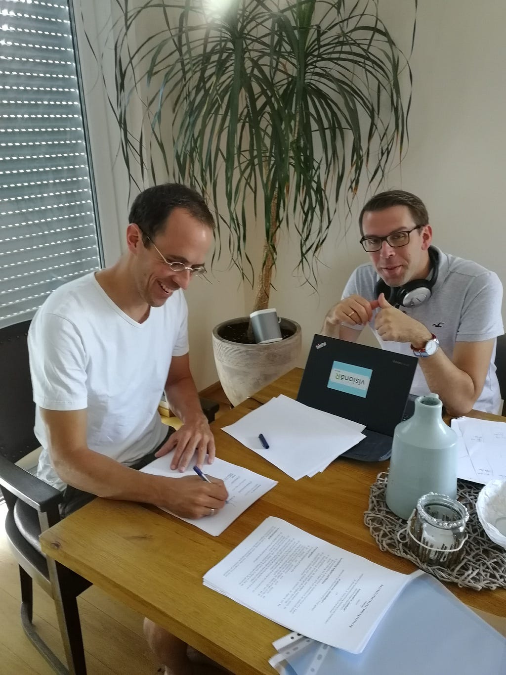 Figure 3: Thomas and I signing the shareholder agreement in my living room