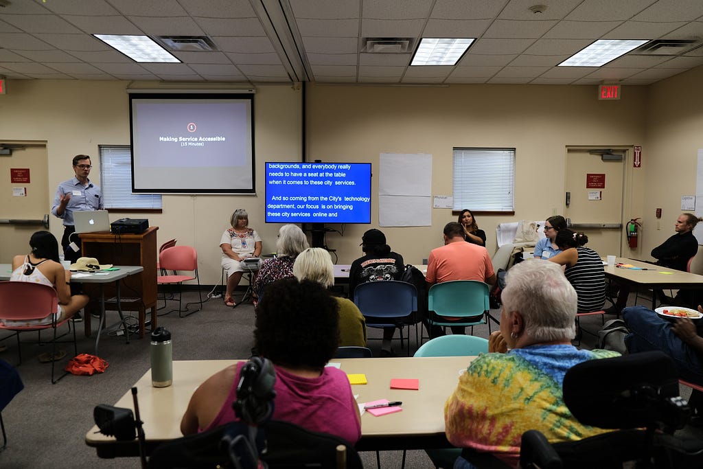 Group of people attend an accessibility workshop “Making services accessible.”