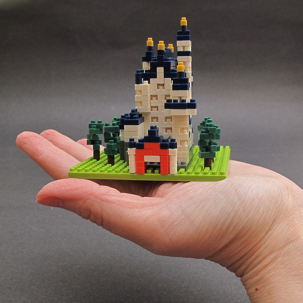 Intricate Nanoblock castle set resting inside a hand