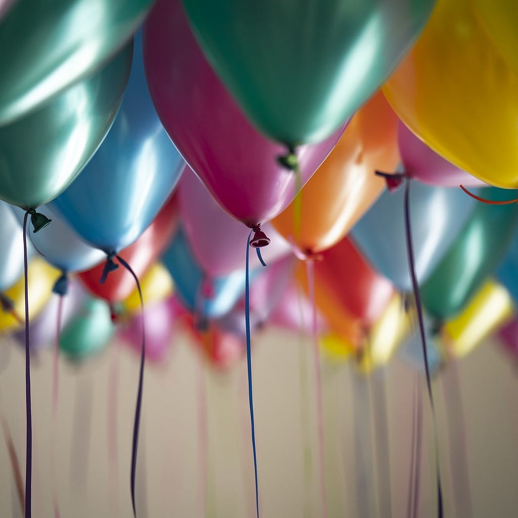 High definition image of different coloured balloons in a room