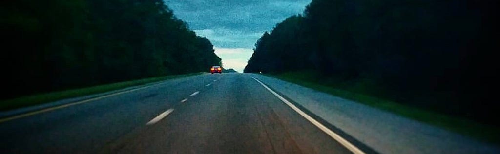 A black-top highway at dusk