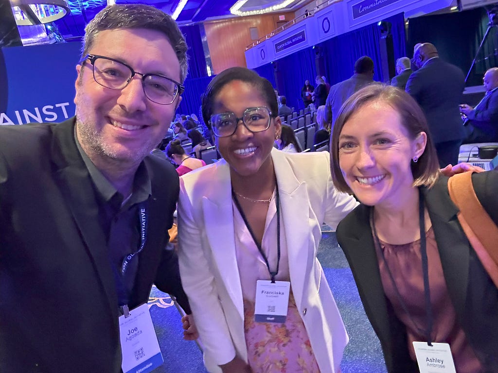 Joe standing with CGI Director of Health Equity Franciscka Lucien and Senior Manager of Health Equity Ashley Ambrose. They are smiling at the camera.