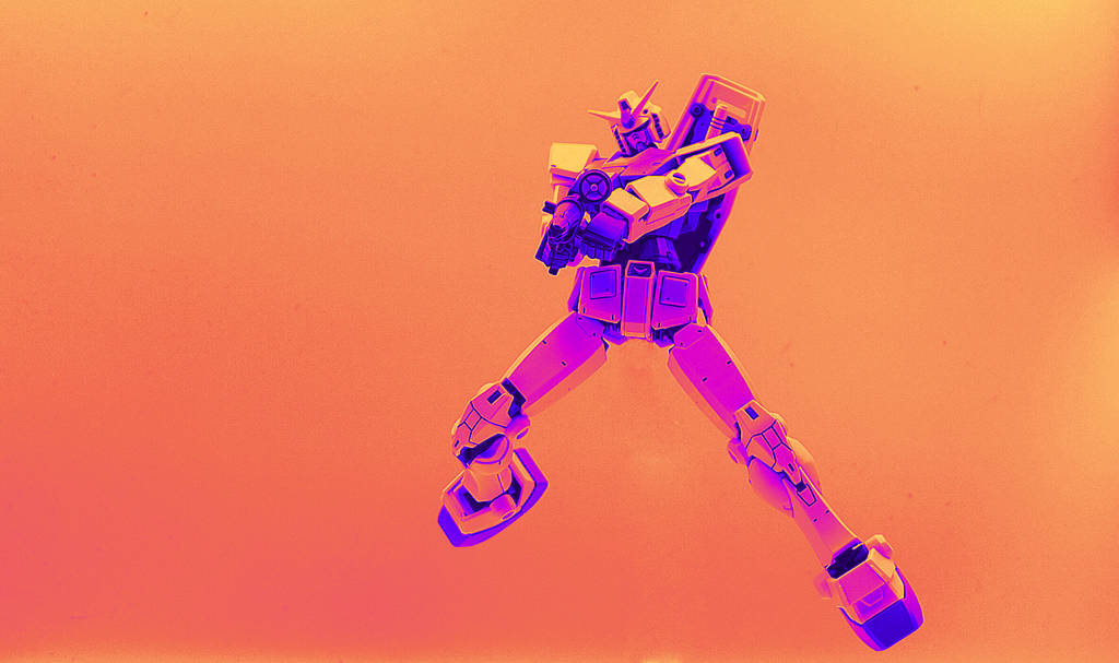 Neon orange, pink, and purple transformer model toy jumping mid-air and shooting at the camera in an action shot. Stylized image, comic-book like. Cover image for Comet ML’s article “Explainable AI: Visualizing Attention in Transformers”