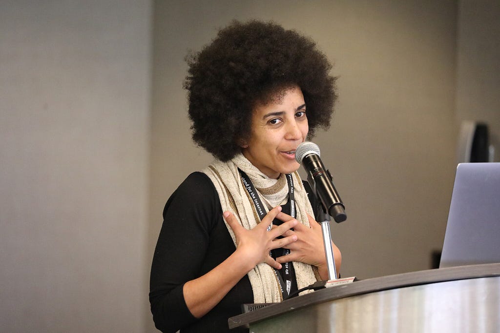 Photo of Timnit Gebru speaking at an event