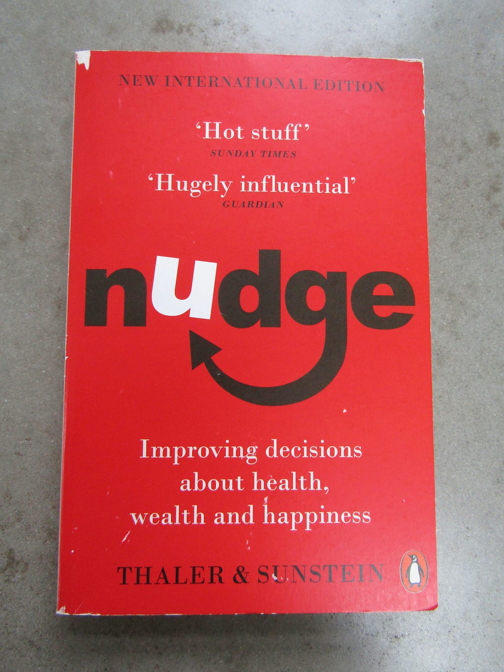 A battered red copy of Nudge by Richard H. Thaler and Bass R. Sunstein