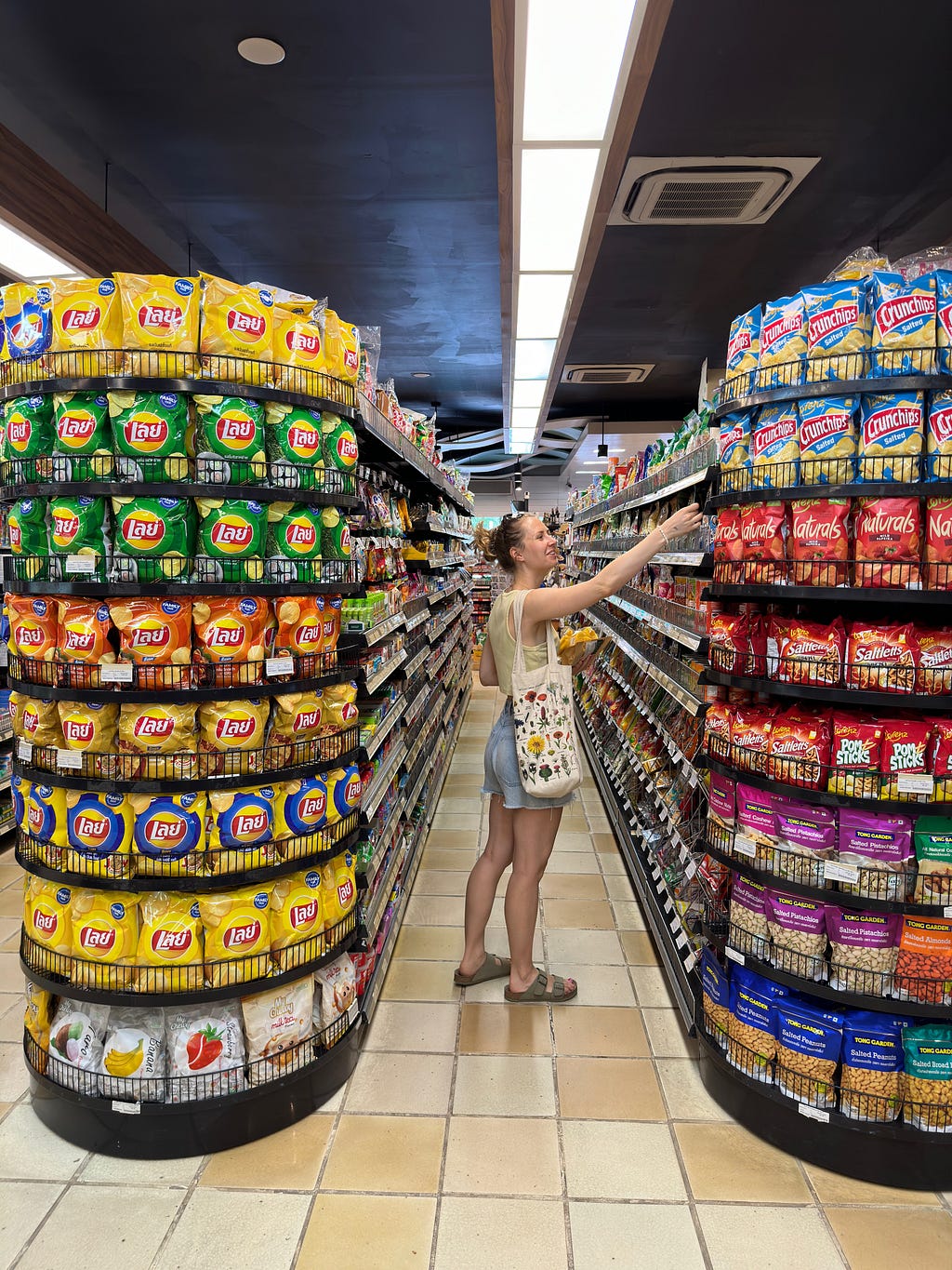 woman standing in a supermarket aisle in a Thai supermarket