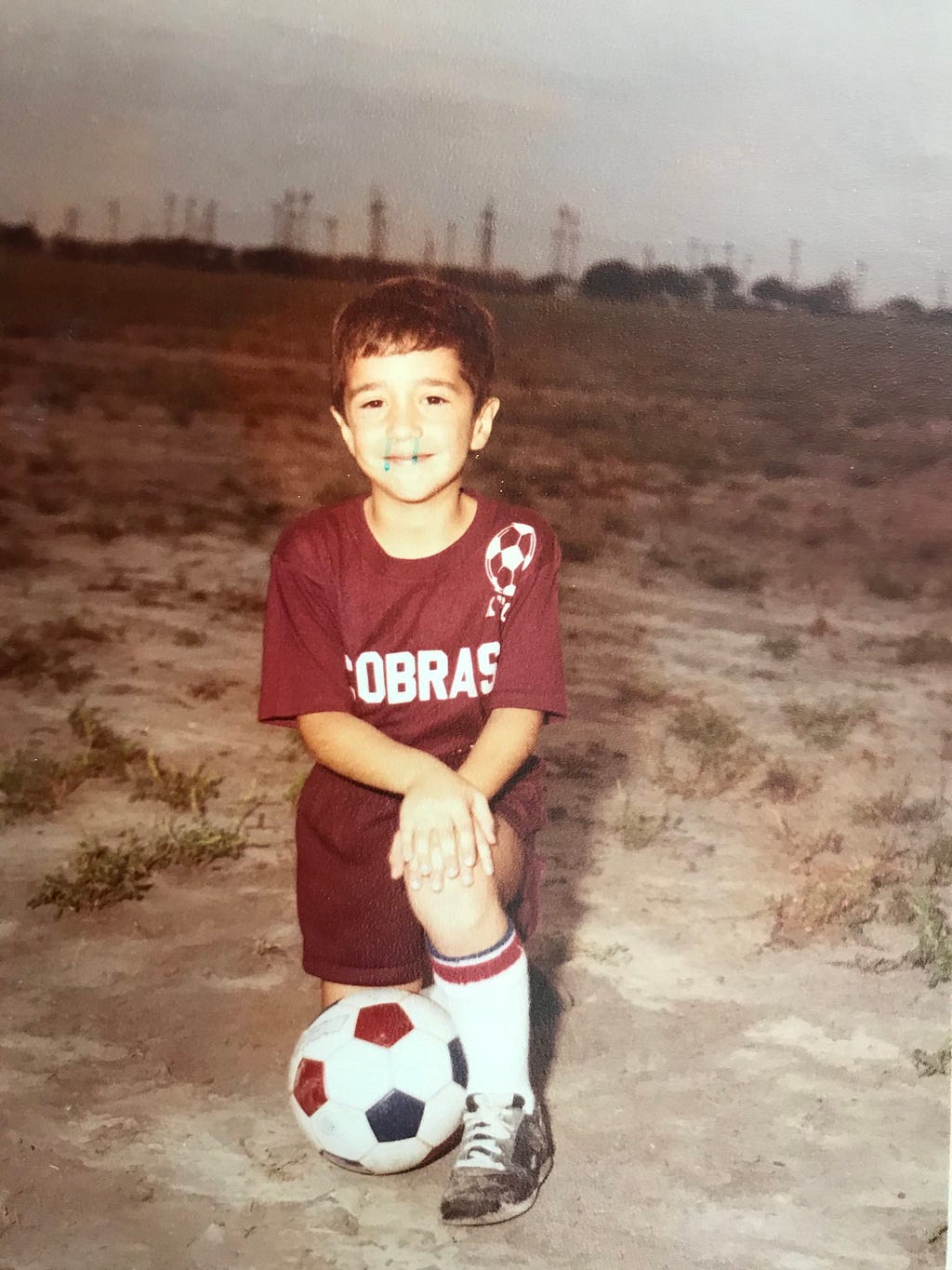 A picture of Gabriel Cruz as a little boy, wearing a red soccer jersey with Cobras, the team name, written across it