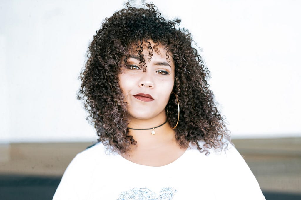 Sabrina May took this photo of a young woman with windswept hair exuding confidence.