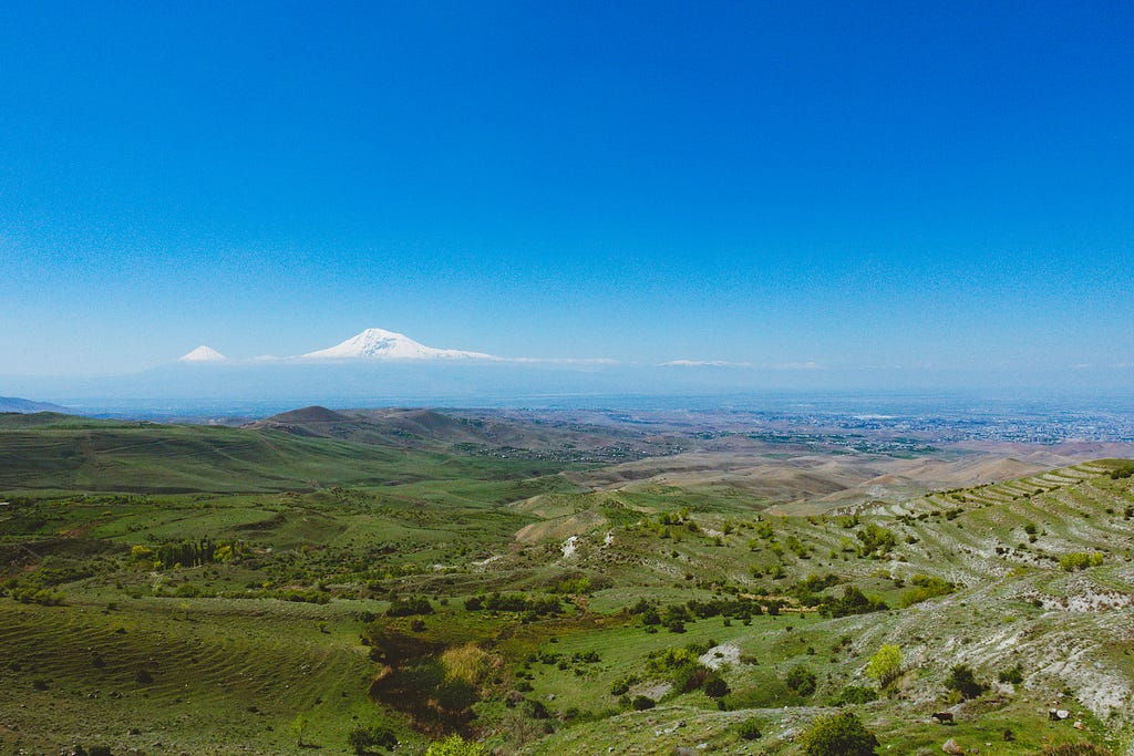 Green fields by the way to Garni, Armenia with mt. Ararat on the horizon