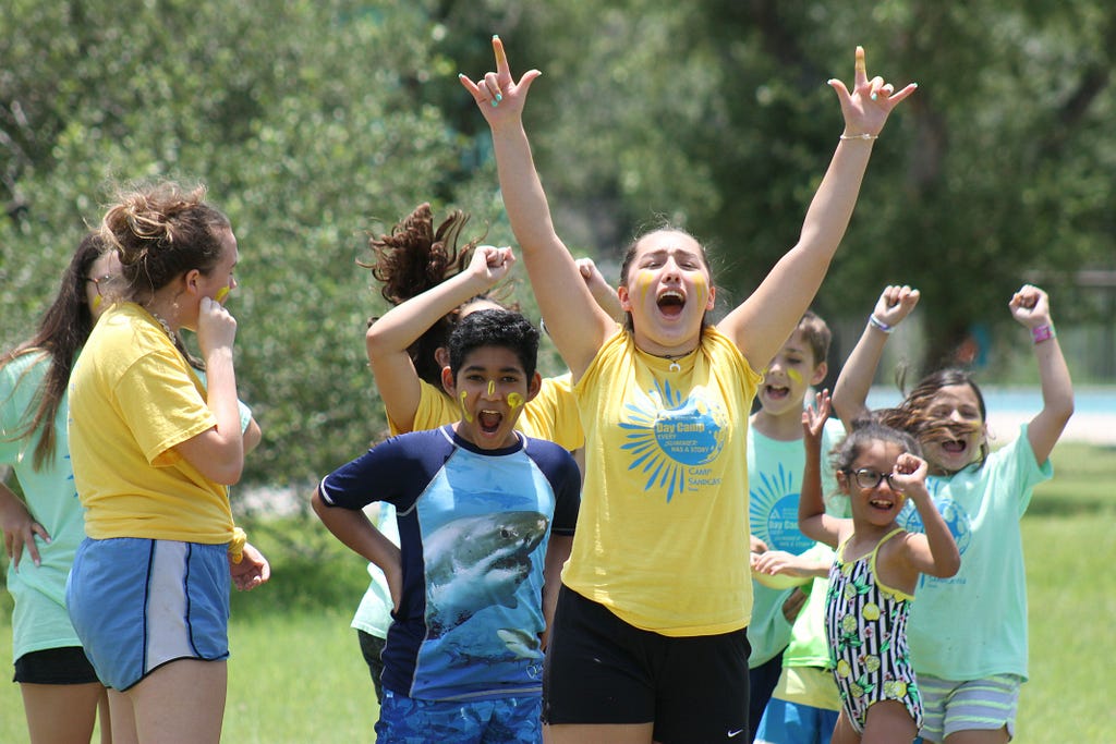 Excited campers cheer at a paint war