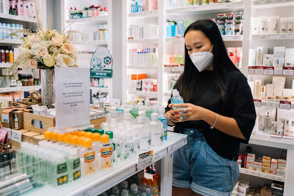 Woman in a pharmacy wearing a face mask