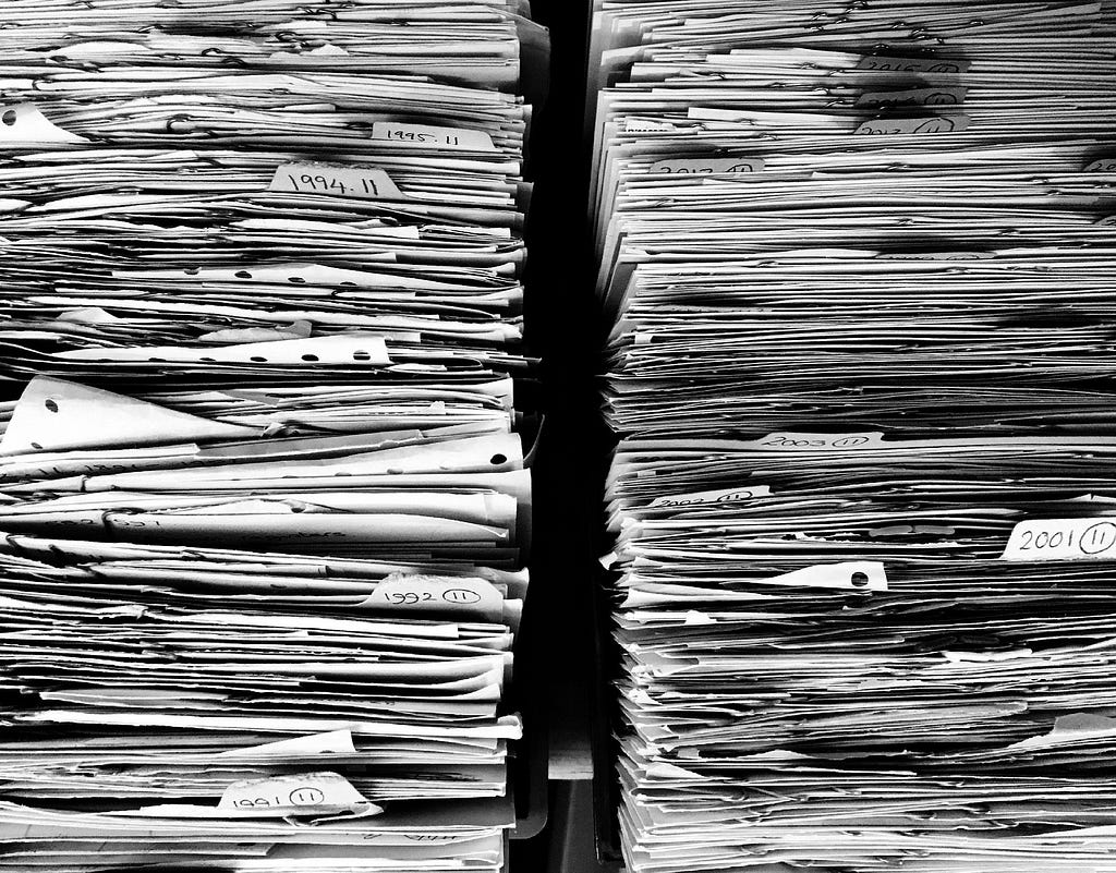 Two very large stacks of paper. Image by Ag Ku from Pixabay