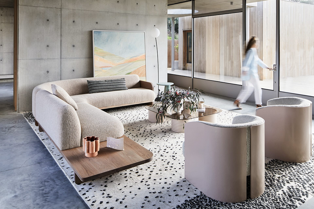 A minimalist living room furniture set in muted beige tones.