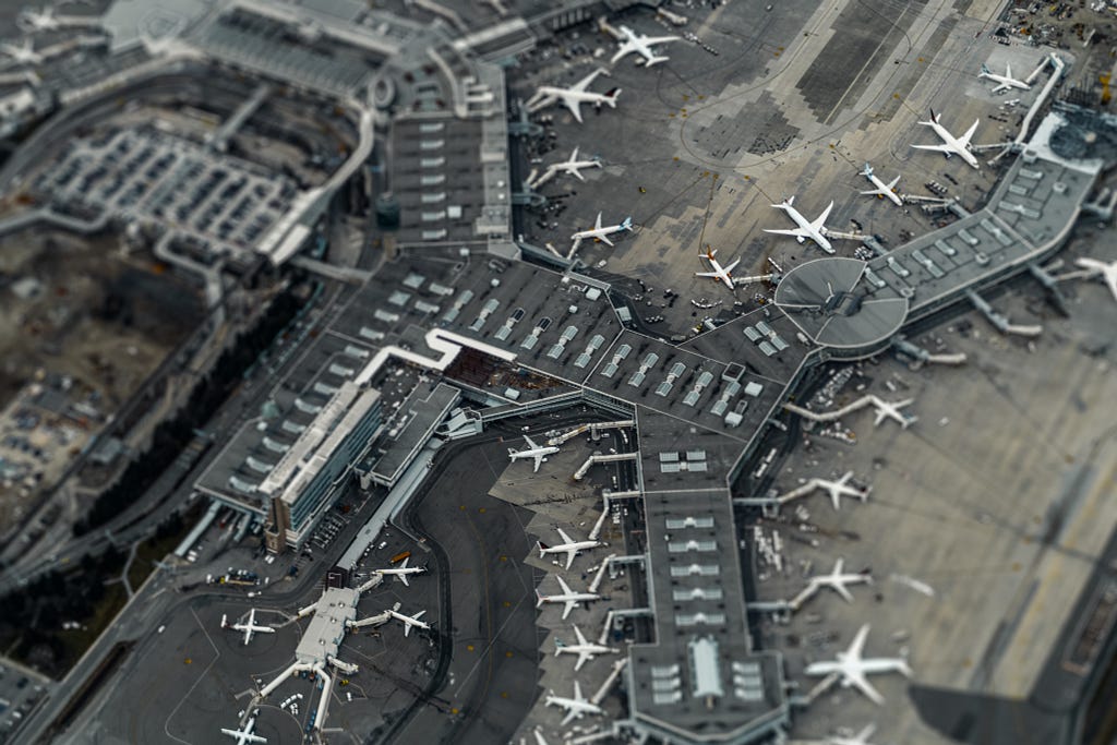 tilt shift picture of an airport terminal from the air