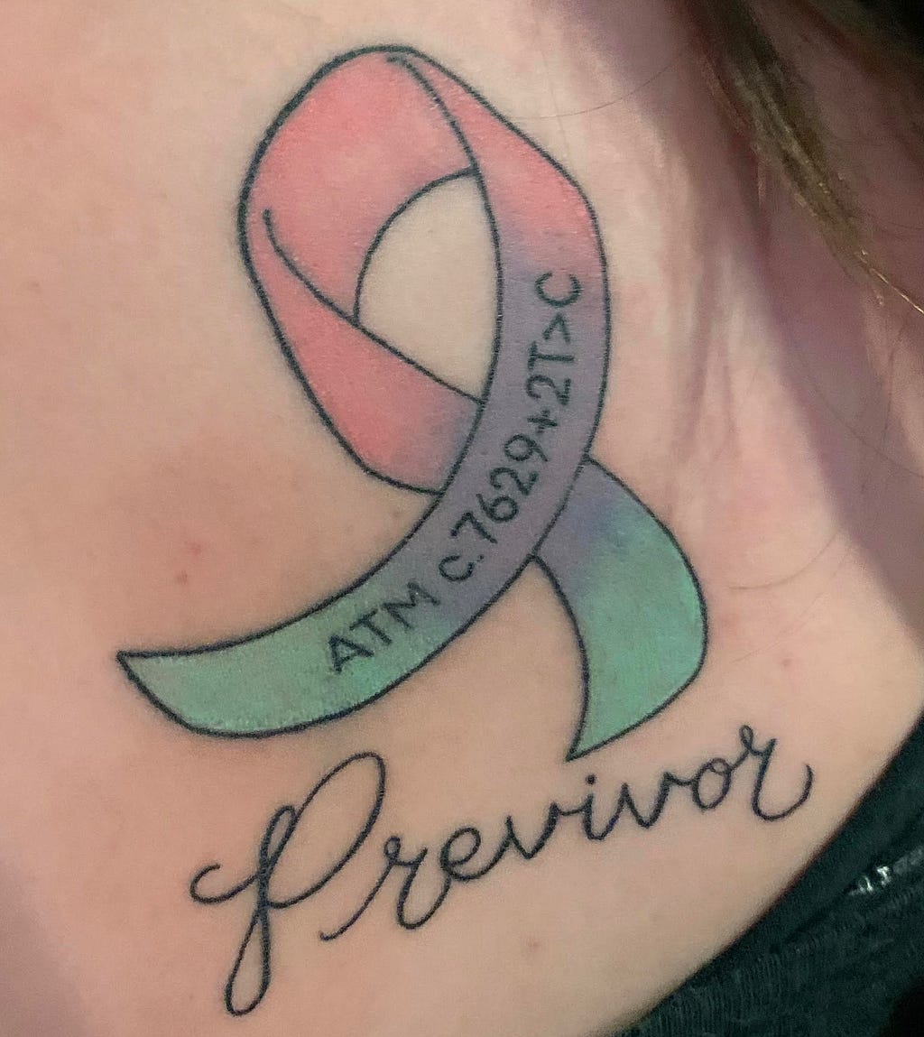 A tattoo shows a multicolored ribbon imprinted with the ATM gene variant, above the word “Previvor.”