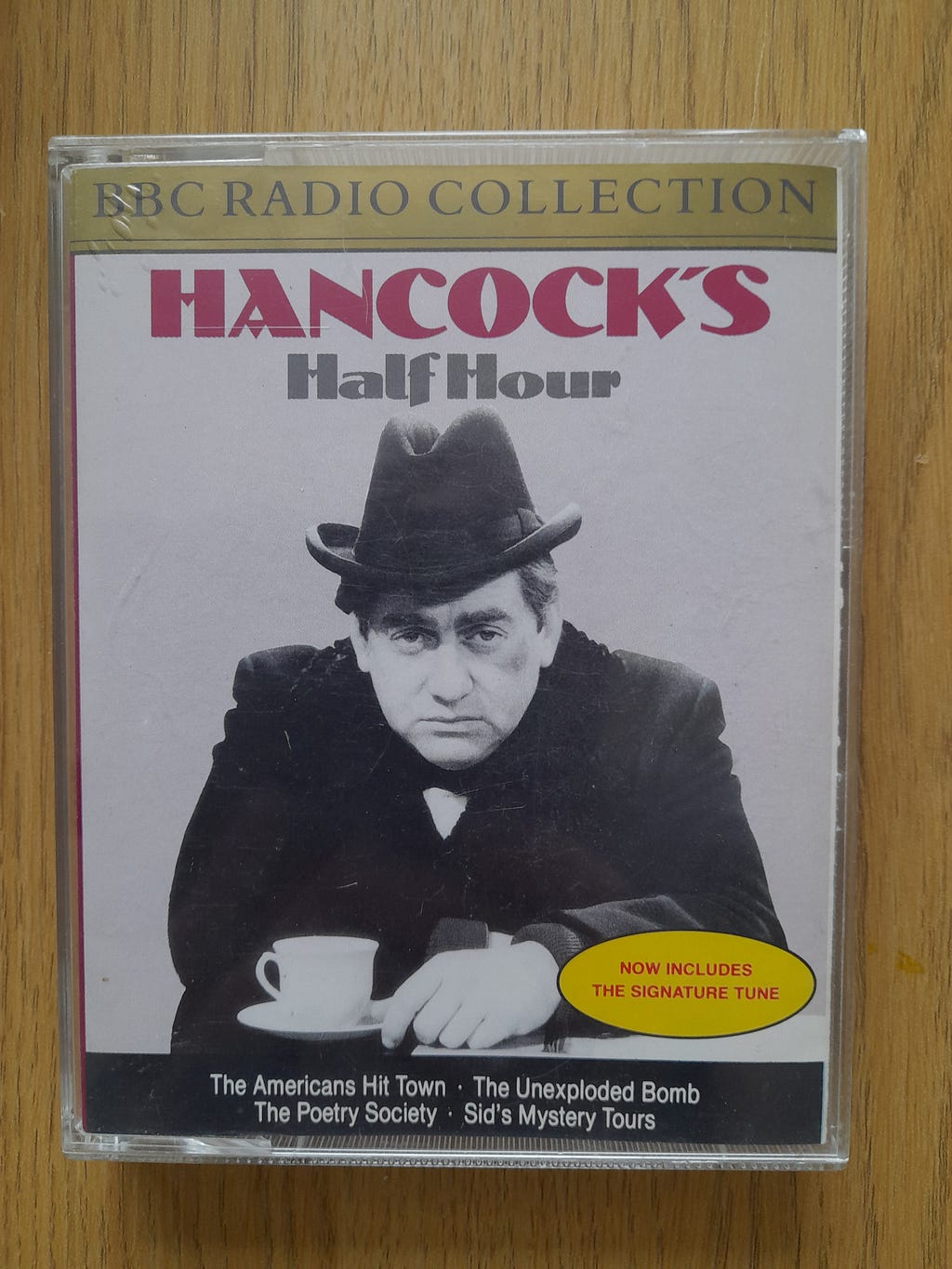 BBC Radio Collection cassette, Hancock’s Half Hour Volume 1. Tony Hancock is pictured on the cover, looking glum, with a cup of tea.