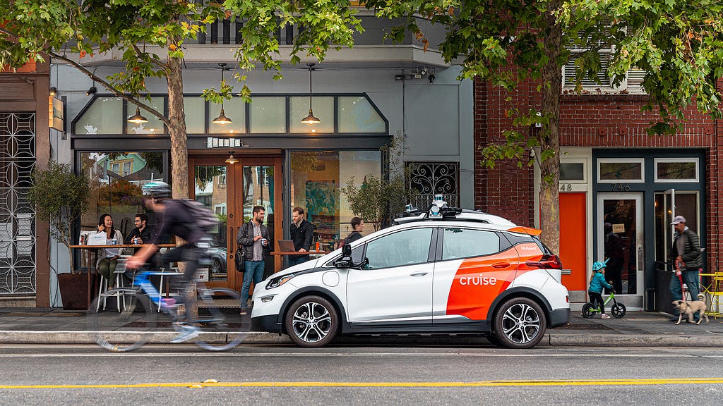 A Cruise autonomous vehicle is parked in front of the Souvla restaurant in San Francisco’s Hayes Valley district.