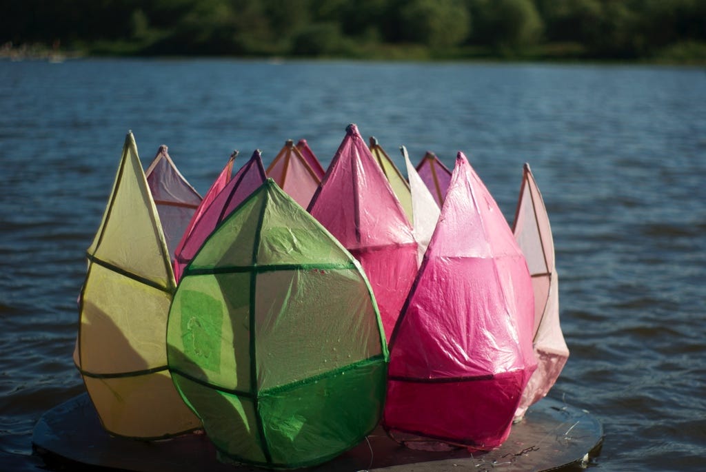 Plastic flower sculpture in a lake.